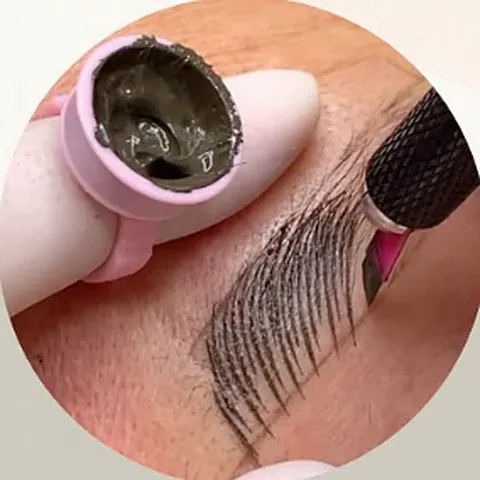 Microblading being done with a manual hand blade, next to a pink pigment ring
